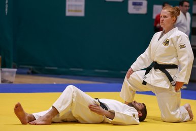 Zwei Judoka beim Training in einer Sporthalle.